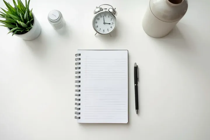 A notebook and coffee by a sunlit window